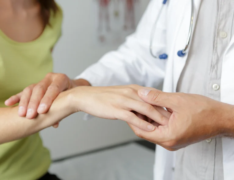 Doctor examining a patient's wrist and forearm