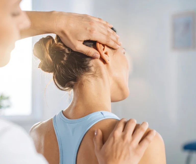 Chiropractor gently adjusting a patient's neck