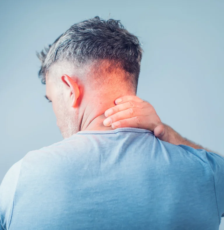 Man rubbing the back of his neck in discomfort