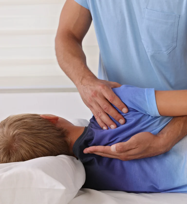 Chiropractor gently adjusting a child on a treatment table