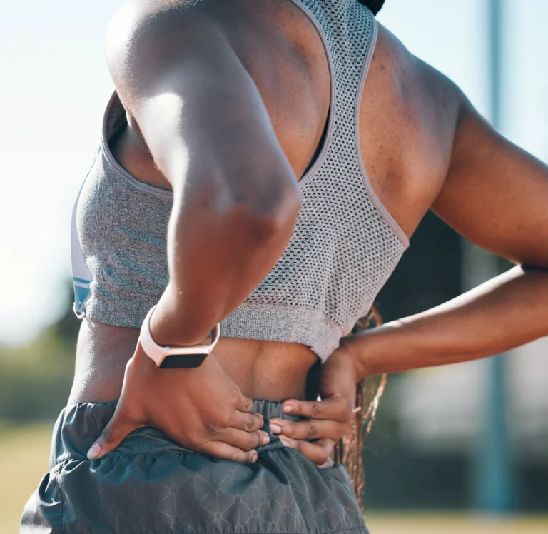 Man experiencing back pain during exercise