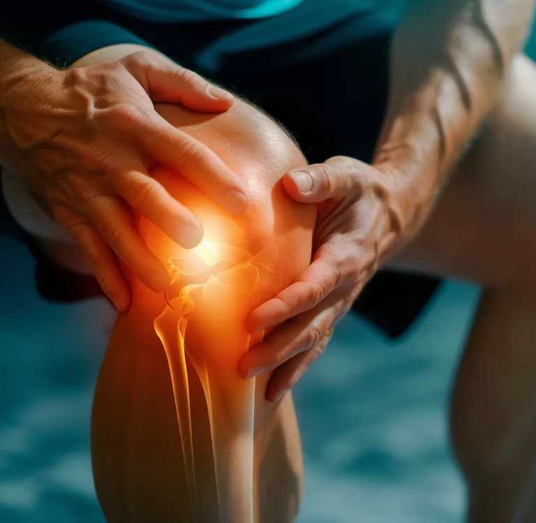 Hands cradling a patient's knee during treatment