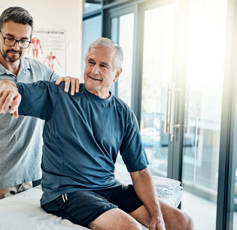 Chiropractor treating a patient in a bright treatment room