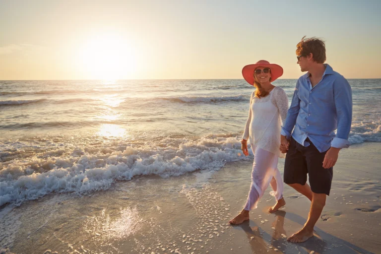 Older couple walking together on a beach